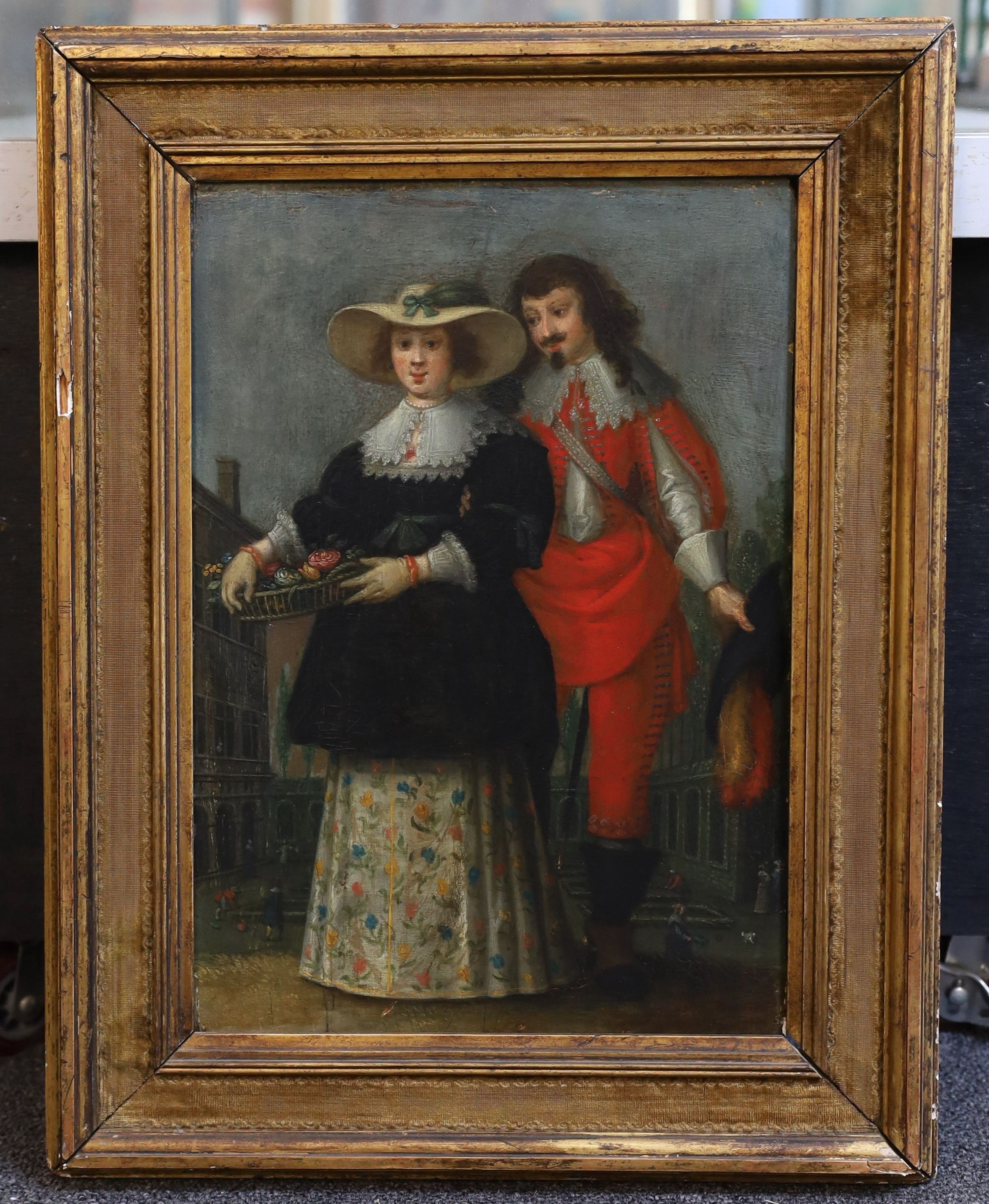Follower of Nicolaes Eliazoon Pickenoy (Dutch, 1588-1656), Study of a courting couple, she holding a basket of flowers, he in a vermillion suit, a courtyard beyond, oil on wooden panel, 34 x 23.5cm